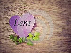 Lent Season, Holy Week and Good Friday concepts - Lent text on purple heart shape paper with flora background. Stock photo.