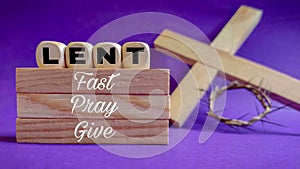 Lent Season,Holy Week and Good Friday concepts - text & x27;lent fast pray give& x27; on wooden blocks in purple vintage