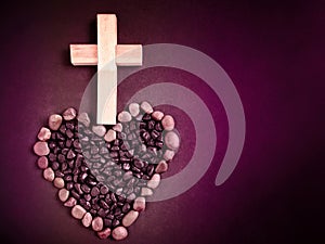 Lent Season,Holy Week and Good Friday concepts - wooden cross image and love shaped stones in vintage background. Stock photo.