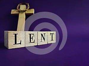 Lent Season,Holy Week and Good Friday concepts - word LENT on wooden blocks in purple vintage background. Stock photo.