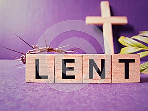 Lent Season,Holy Week and Good Friday concepts - word lent on wooden blocks in purple vintage background. Stock photo.