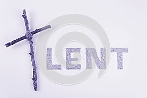 Lent word written in ash with Christian Cross. Concept for Lent Season, Holy Week, Palm Sunday and Good Friday.