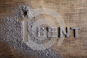 Lent word written in ash, dust as fast and abstinence period concept. Top view photo