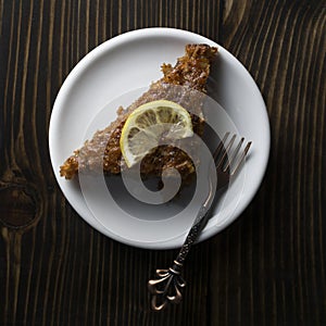 Lenten cake with lemon on plate.