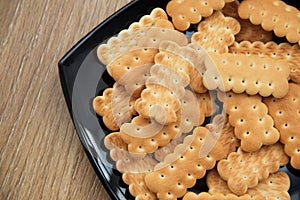 Lenten cookies in a black plate on the table.