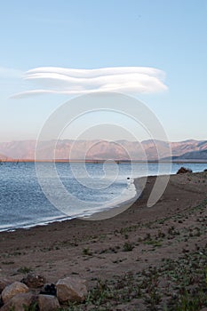 Lenticular cloud hovering above drought stricken Lake Isabella in the southern range of California's Sierra Nevada mountains