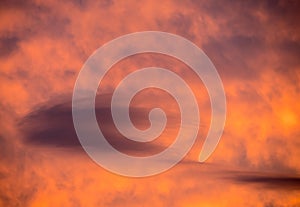 Lenticular clouds forming at sunset