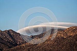 Lenticular clouds over mountain