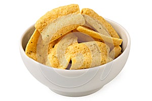 Lentil chips in a white ceramic bowl isolated on white