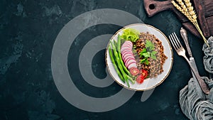 Lentil with radish, cherry tomatoes, beans and vegetables. Healthy food. On the stone table.