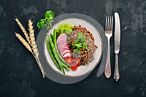 Lentil with radish, cherry tomatoes, beans and vegetables. Healthy food. On the stone table.