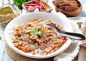 Lentil soup with chicken and pepperoni sausage, onion, carrot, sweet pepper, garlic and parsley.