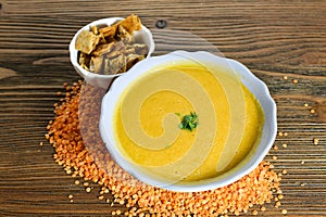 Lentil soup with crackers served in bowl isolated on table side view of arabian food