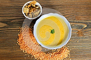 Lentil soup with crackers served in bowl isolated on table top view of arabian food