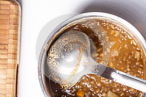 Lentils potage homemade close up still with a metal spoon on a pot