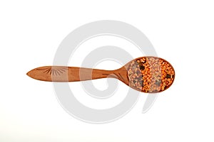 Lentils with spices in wooden spoon on white background, close-up. Ingredients for Indian Masurdal soup. Dry legumes. Long-term