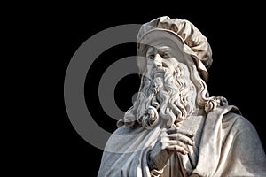 Leonardo Da Vinci statue on black background photo