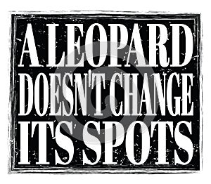 A LEOPARD DOESN`T CHANGE ITS SPOTS, text on black stamp sign photo