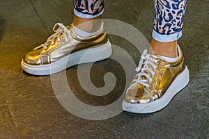 Woman With Golden Sneakers