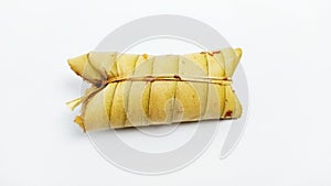 Lepet or leupeut Indonesian traditional food with glutinous rive and grated coconut ingredients isolated on white background