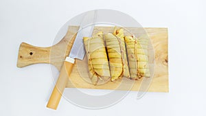 Lepet or leupeut Indonesian traditional food with glutinous rive and grated coconut ingredients on white background