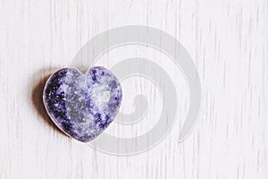 Lilac lepidolite stone heart on white background