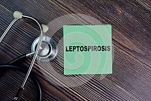 Leptospirosis write on sticky notes isolated on Wooden Table. medical concept