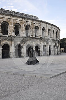 Les Arenes old Roman Amphitheater with Matador statue front of from Nimes France