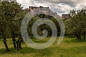 Les beaux de provence France with olive trees in forground on a cloudy day,famouse tourist destination in Provence
