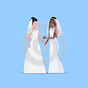 Lesbian brides couple same gender happy married homosexual family wedding concept two mix race girls standing together