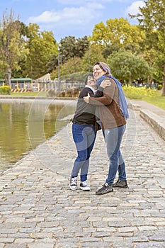 Lesbian couple hugging in a park