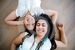 Lesbian couple lying on floor