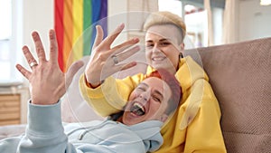 Lesbian Couple Showcasing Engagement Rings, Celebrating Commitment