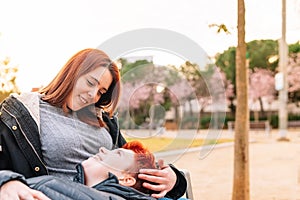 a lesbian couple sitting in a public park, women loving each other.