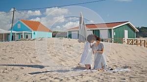 Lesbian couple using smartphone checking beach pictures. Two girls resting shore