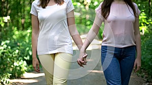 Lesbian couple walking together, holding hands, free choice of love no prejudice