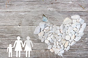 Lesbian Family on wooden background with white stones heart and blue butterfly