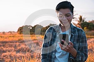 A lesbian or involving homosexual woman in a plaid shirt using smartphone outdoor photo