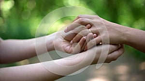 Lesbian wedding, same-sex partners wearing rings on ceremony, creating family