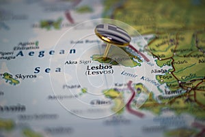 Lesbos, a Greek island pinned on a map with the flag of Greece