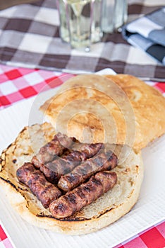 Leskovacki Cevapi u lepinji - Grilled beef links served in home made bun photo