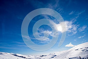 Lessinia Plateau in Winter with Snow and a Beautiful Blue Sky with Clouds