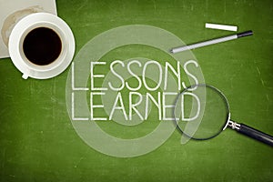 Lessons learned concept on green blackboard photo