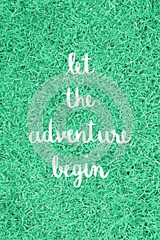 Let the adventure begin hand lettering on green grass field