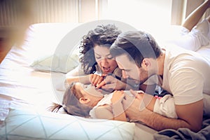 Let we count your teeth. Young parents with their little girl.