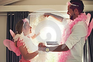 Let the fun begin. Cropped shot of a father and his little daughter having fun at home.