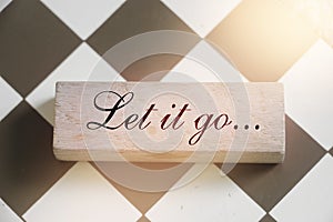 Let It Go wooden sign with a chess on background. Philosophy forgiveness concept