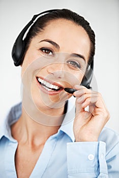Let her help you with your query. Attractive female customer service agent using a headset for client services calls.