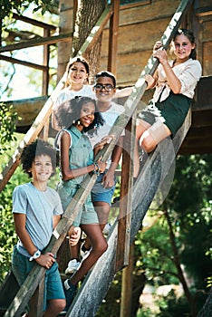 Let kids be kids. Shot of a group of teenagers standing next to a treehouse at summer camp.