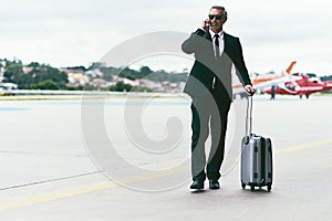 Let me call you back, Im about to board. Full length shot of a handsome mature businessman walking with his luggage